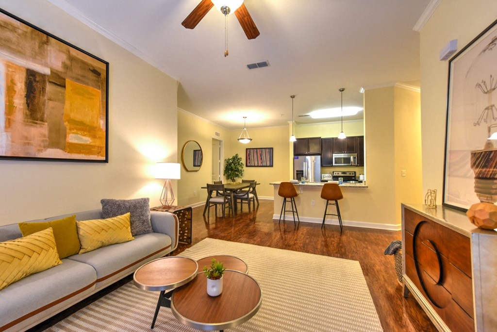 A living room with a grey sofa and a wooden coffee table at Alaqua, Florida, 32258