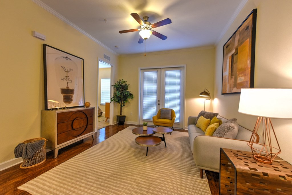 A living room with a yellow wall and a ceiling fan at Alaqua, Florida, 32258