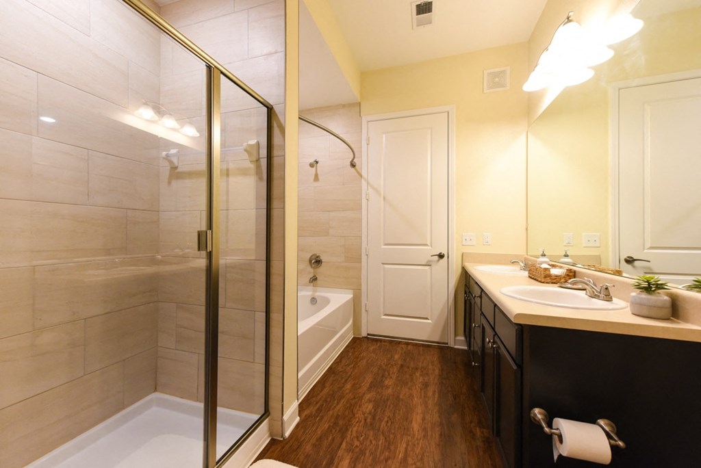 A bathroom with a white tub and a white sink at Alaqua, Florida, 32258