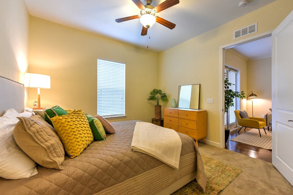 A bedroom with a bed, dresser, and chair at Alaqua, Florida, 32258