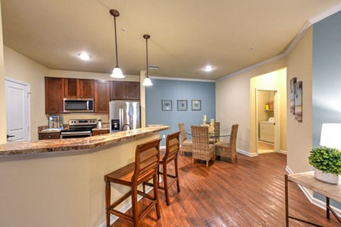 A kitchen with wooden chairs and a counter at Cabana Club - Galleria Club Apartments, Jacksonville, 32256