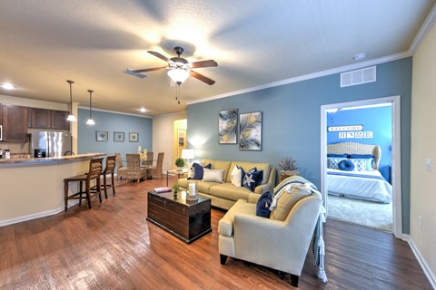 A living room with a couch, chairs, and a coffee table at Cabana Club - Galleria Club Apartments, Florida 32256