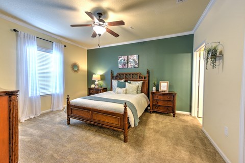 A bedroom with a bed, dresser, and window at Cabana Club - Galleria Club Apartments, Jacksonville, FL, 32256