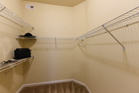 A small closet with a hat on a shelf at Cabana Club - Galleria Club Apartments, Jacksonville, Florida