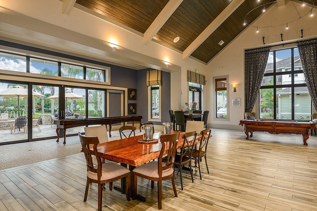 a large gathering room with a pool table and ping pong table a large gathering room with a pool table and ping pong table at Cabana Club - Galleria Club, Jacksonville, FL