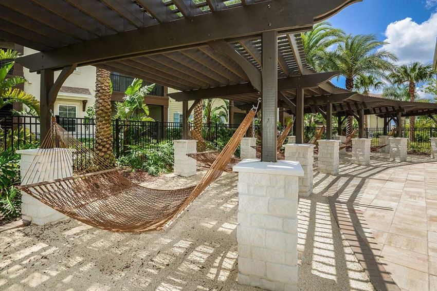 a hammock is set up on a patio in front of a building a hammock is set up on a patio in front of a building at Cabana Club - Galleria Club, Jacksonville, FL