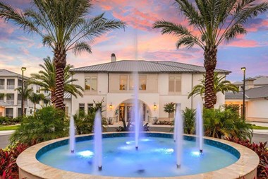 a house with a fountain in front of it - Photo Gallery 4