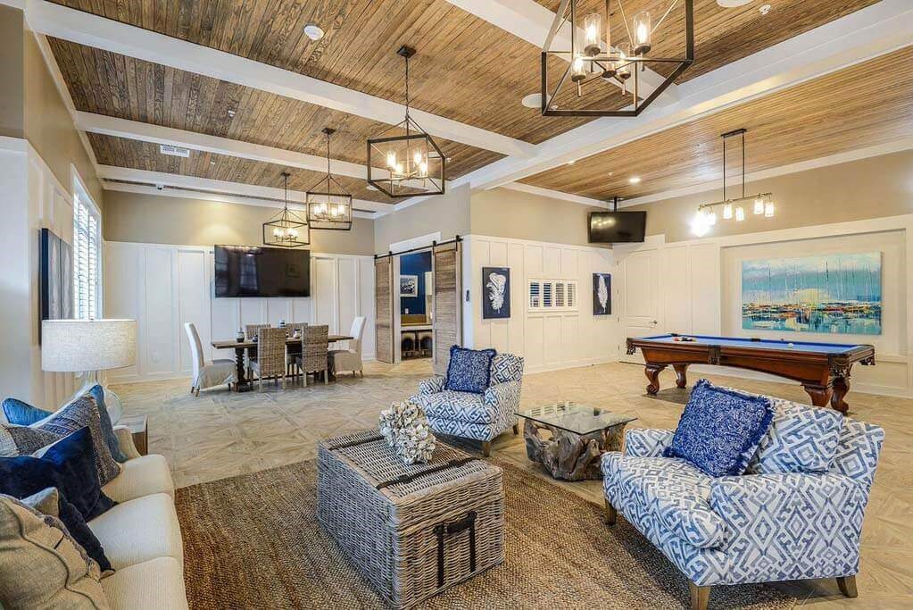 a living room filled with furniture and a pool table  at Palm Bay Club, Florida, 32258