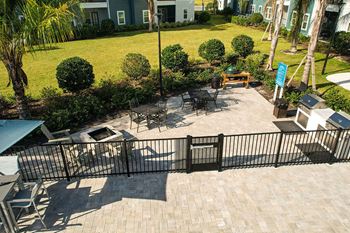 a patio with a grill and tables and chairs  at Fountainhead, Florida, 32258