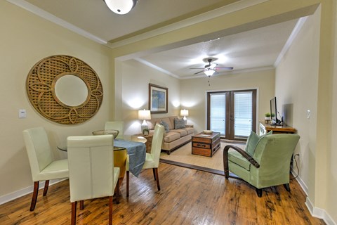 a living room and dining room with a couch and a table at Hacienda Club, Jacksonville, FL, 32256