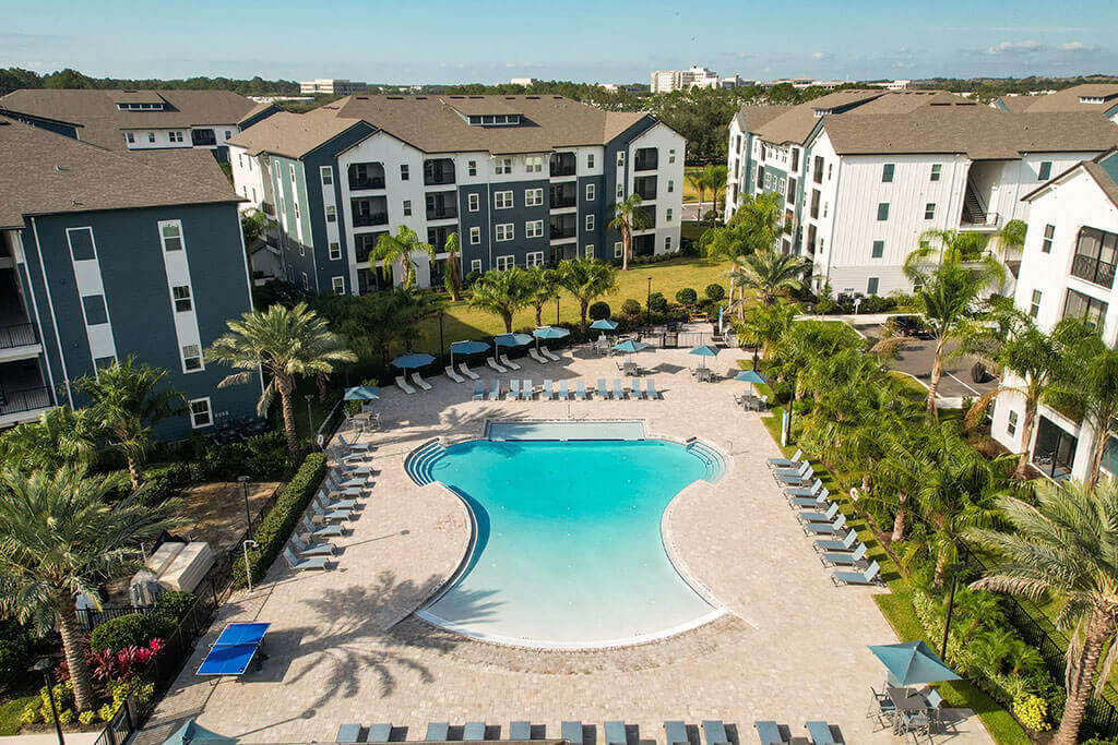 an aerial view of the resort style pool with chaise lounge chairs and umbrellas  at Fountainhead, Florida