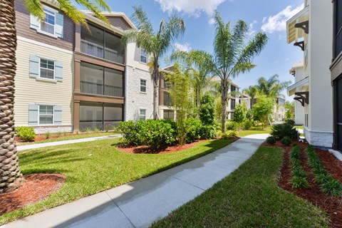 A row of apartment buildings with a sidewalk in front at Cabana Club - Galleria Club Apartments, Jacksonville