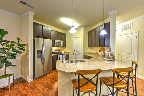 A kitchen with a refrigerator, microwave, oven, sink, and cabinets at Cabana Club - Galleria Club Apartments, Florida