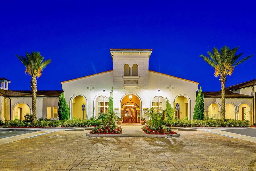 a house with a driveway and palm trees in front of it  at Hacienda Club, Jacksonville, FL, 32256