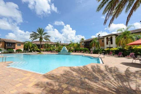 a large swimming pool with a fountain in front of a building  at Hacienda Club, Jacksonville