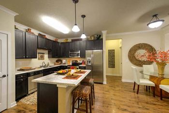 a kitchen with black cabinets and a white counter top  at Hacienda Club, Jacksonville, FL