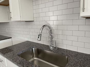 a kitchen with a sink and a faucet  at Fountainhead, Jacksonville, 32258