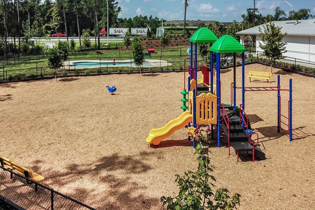 a playground with a slides and a monkey bars  at Palm Bay Club, Florida