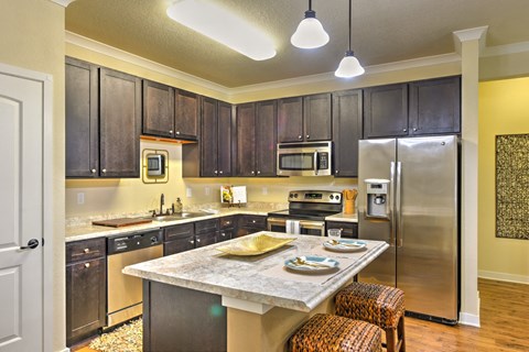 a kitchen with stainless steel appliances and a marble counter top at Hacienda Club, Jacksonville, FL