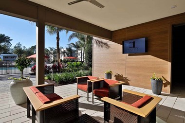 a patio with chairs and a tv - Photo Gallery 3