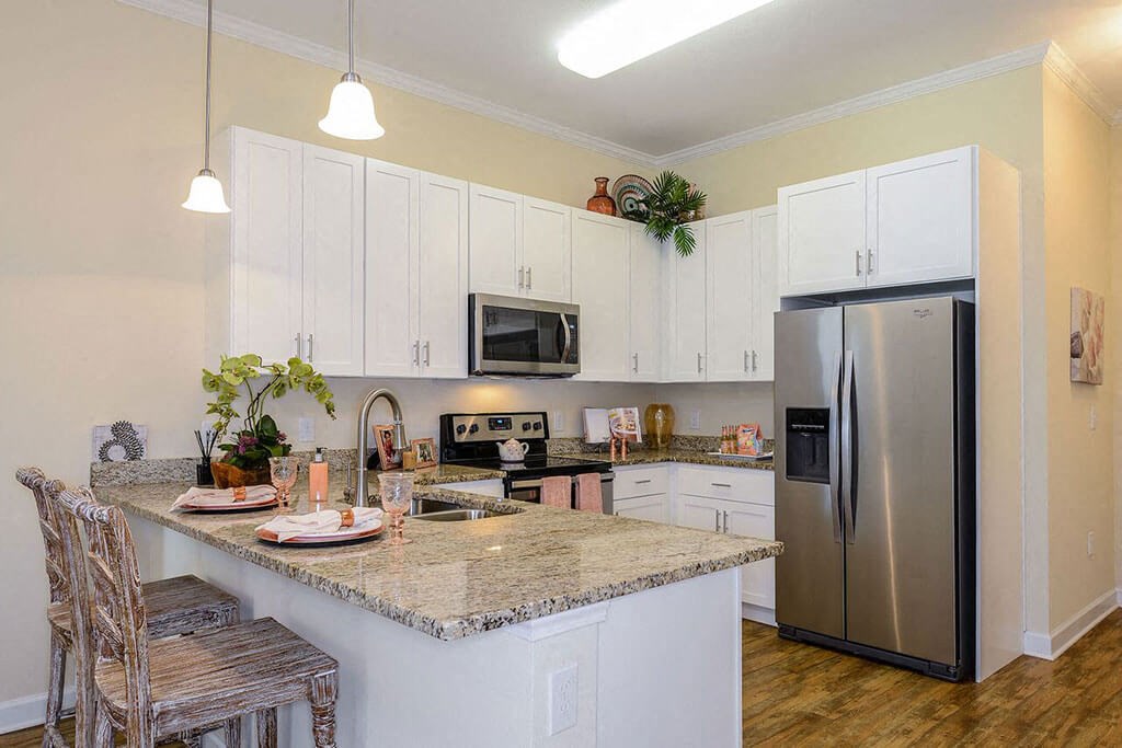 a kitchen with white cabinets and a granite counter top a kitchen with white cabinets and a granite counter top at Palm Bay Club, Jacksonville, 32258