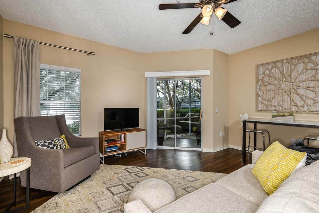a living room with a couch and a tv  at Ocean Park, Jacksonville Beach