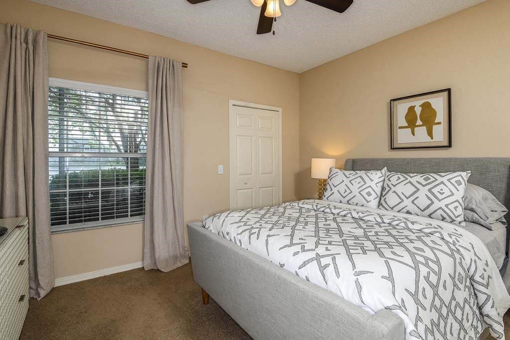 a bedroom with a bed next to a window  at Ocean Park, Florida