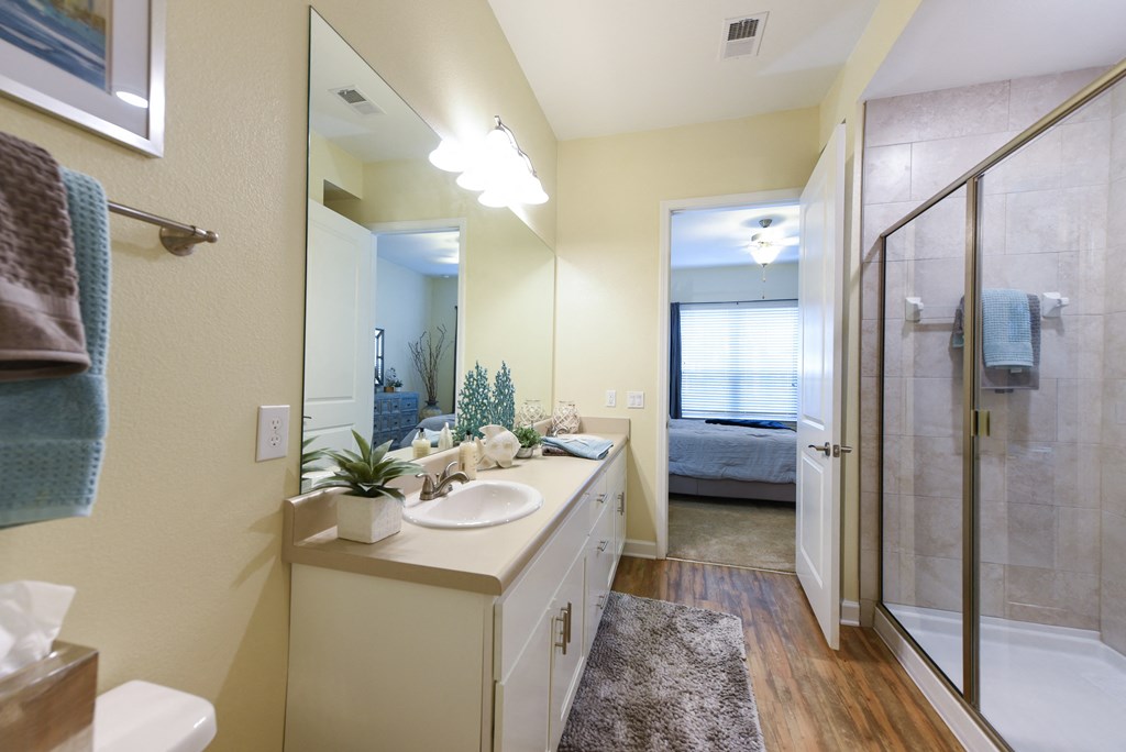 a bathroom with a large mirror and a walk in showerat Palm Bay Club, Florida, 32258