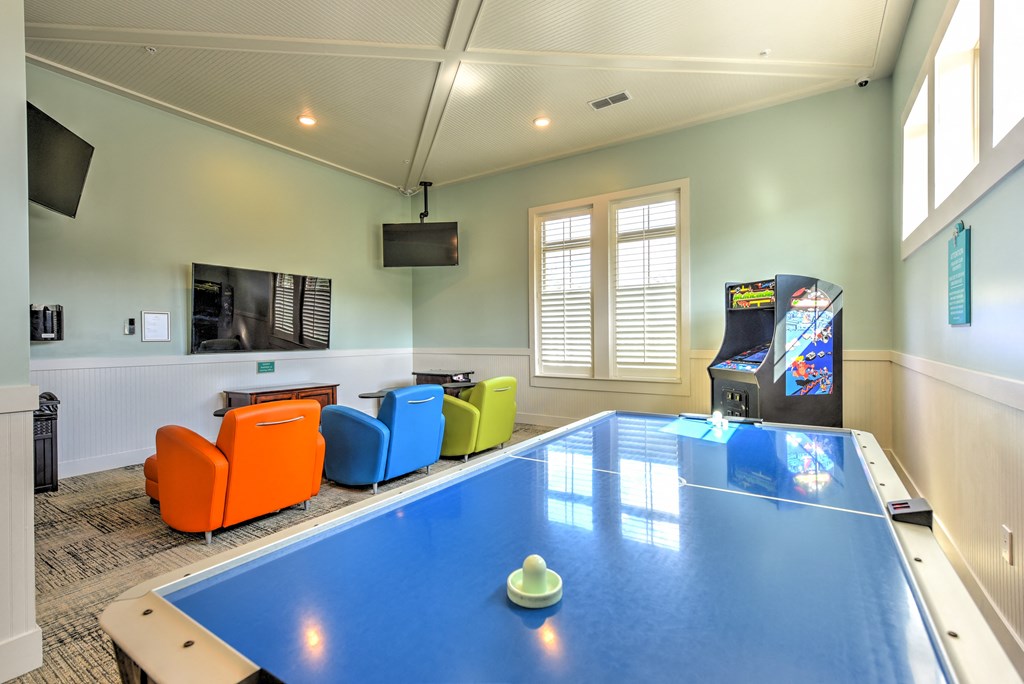 a games room with a ping pong table and a video gameat Palm Bay Club, Jacksonville, Florida