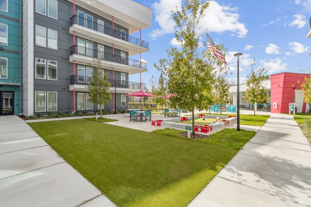 A sunny day at a modern apartment complex with a playgroundat Pinnacle Apartments, Jacksonville, FL