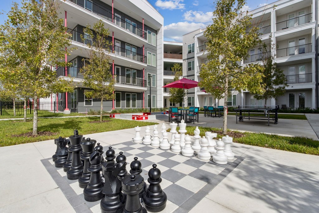 A giant chess set is set up on a sidewalk in front of apartment buildingsat Pinnacle Apartments, Jacksonville, FL