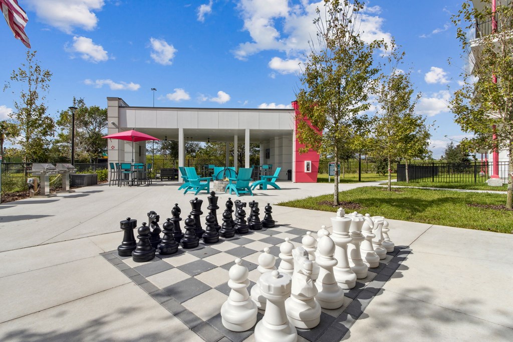 A giant chess set is set up on a concrete surface.at Pinnacle Apartments, Jacksonville, FL