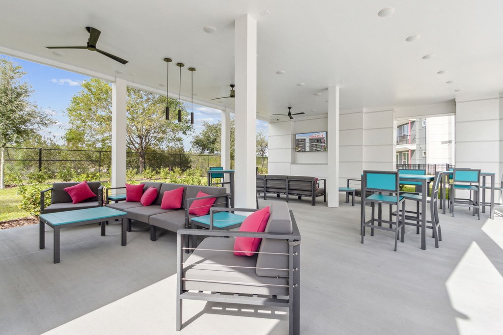 A patio with a table and chairs with a fan in the backgroundat Pinnacle Apartments, Jacksonville, FL