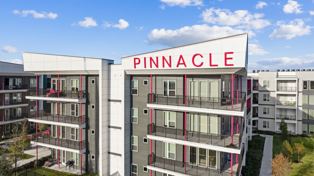 A modern apartment building named Pinnacle is shown in the imageat Pinnacle Apartments, Jacksonville, FL