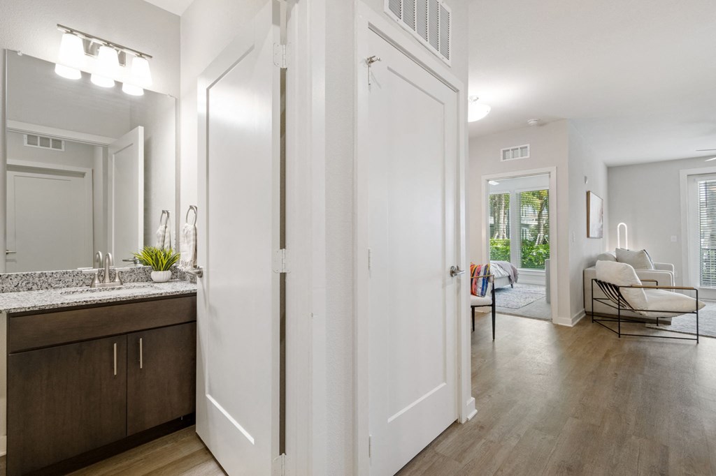 A bathroom with a vanity and a mirrorat Pinnacle Apartments, Jacksonville, FL