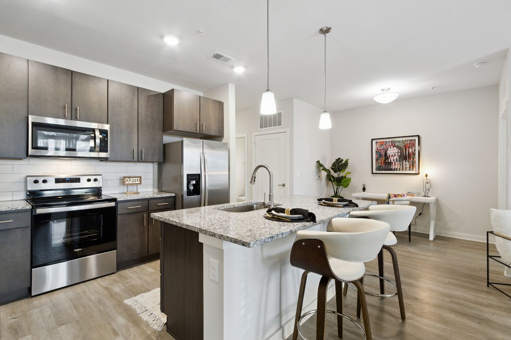 A modern kitchen with a large island and stainless steel appliancesat Pinnacle Apartments, Jacksonville, FL