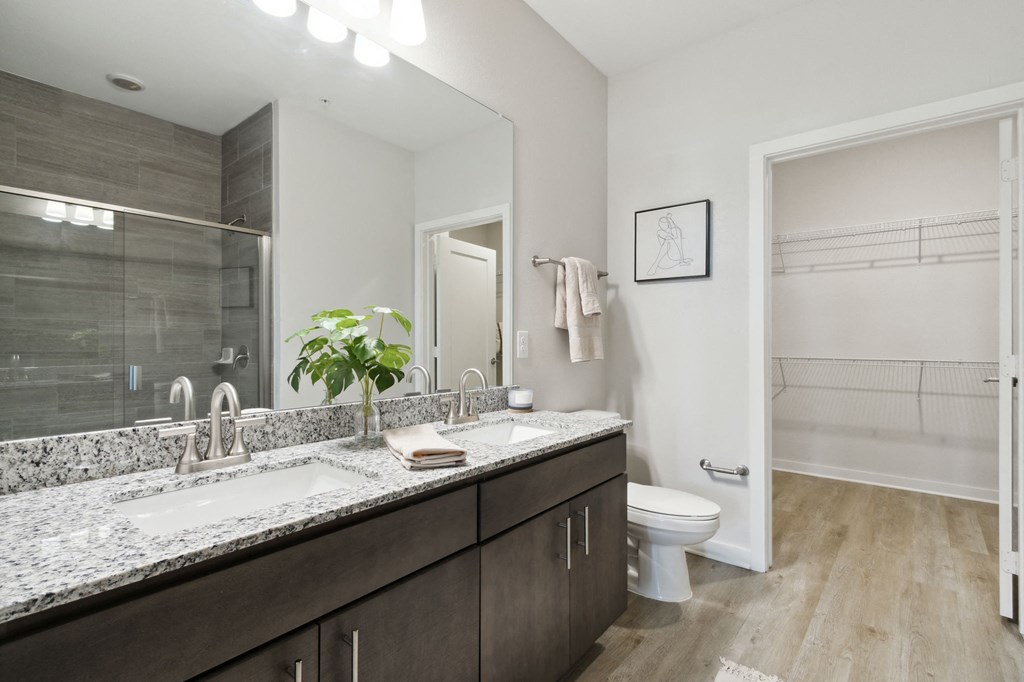 A bathroom with a marble countertop and a walk-in showerat Pinnacle Apartments, Jacksonville, FL