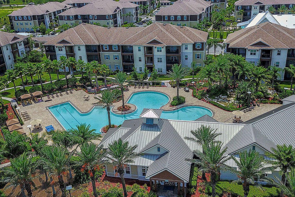 an aerial view of a resort style swimming pool with palm trees  at Cabana Club - Galleria Club, Florida