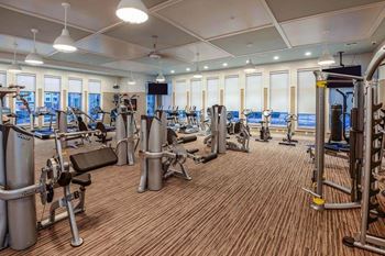 a room filled with lots of different types of exercise equipment  at Palm Bay Club, Florida, 32258