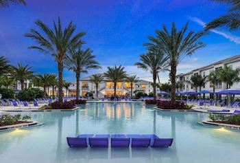 a resort style pool with lounge chairs and palm trees  at Palm Bay Club, Jacksonville, Florida