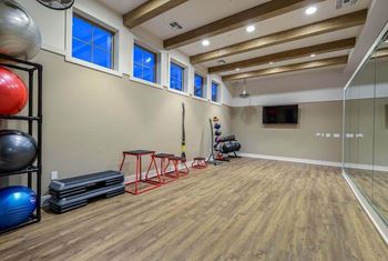 a workout room with a treadmill and weights  at Palm Bay Club, Florida