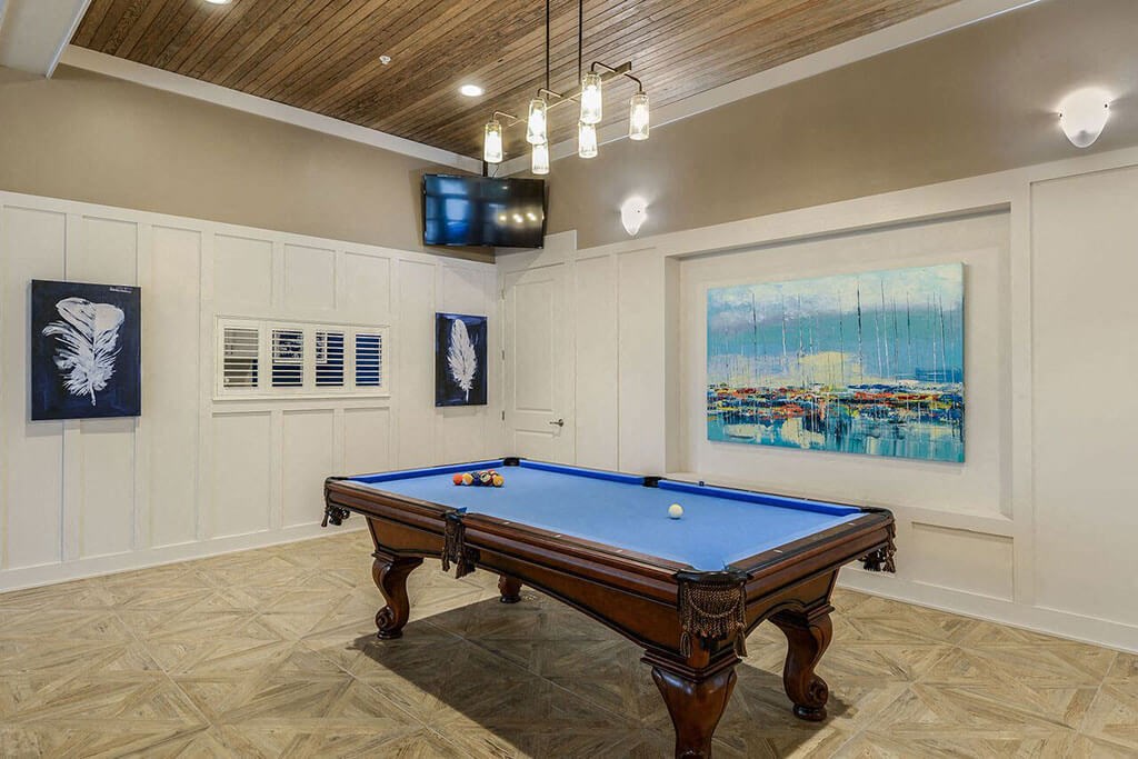 a game room with a pool table and a television  at Palm Bay Club, Jacksonville