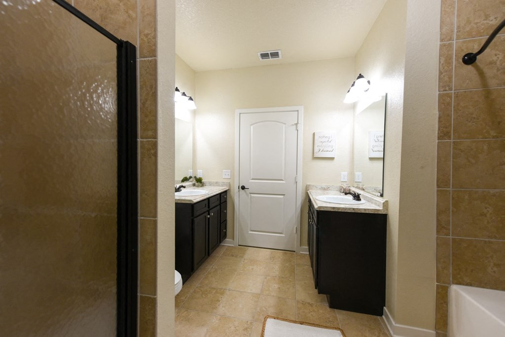 a bathroom with a shower sink and toilet and a sink and a mirror at Hacienda Club, Florida