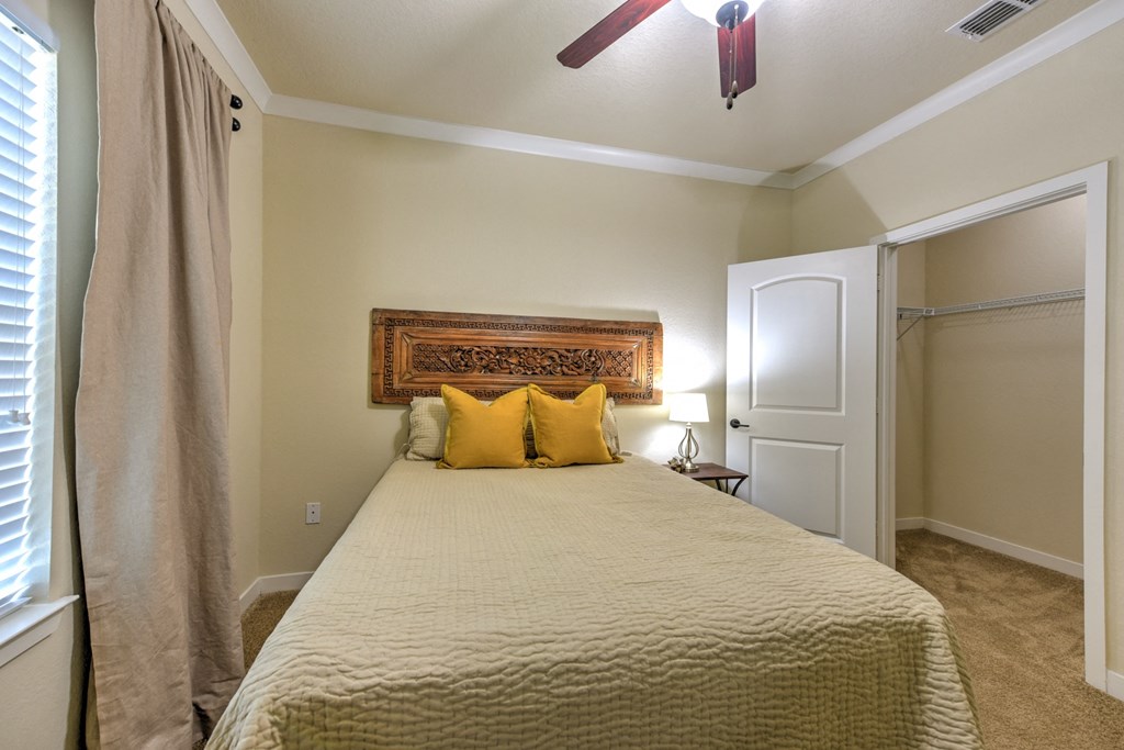 a bedroom with a large bed and a ceiling fan at Hacienda Club, Jacksonville, 32256