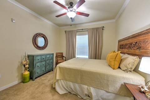 the master bedroom has a large bed and a ceiling fan at Hacienda Club, Jacksonville, FL, 32256