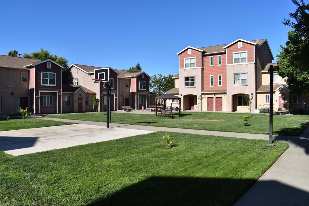 a row of town houses on a green lawn
