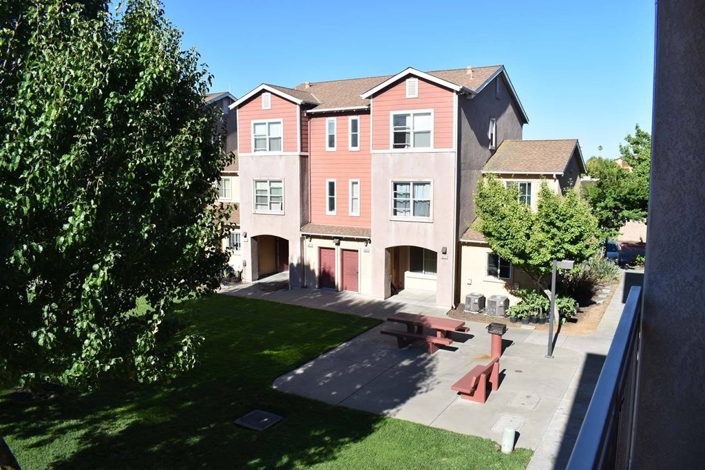 an apartment building with a picnic table in front of it