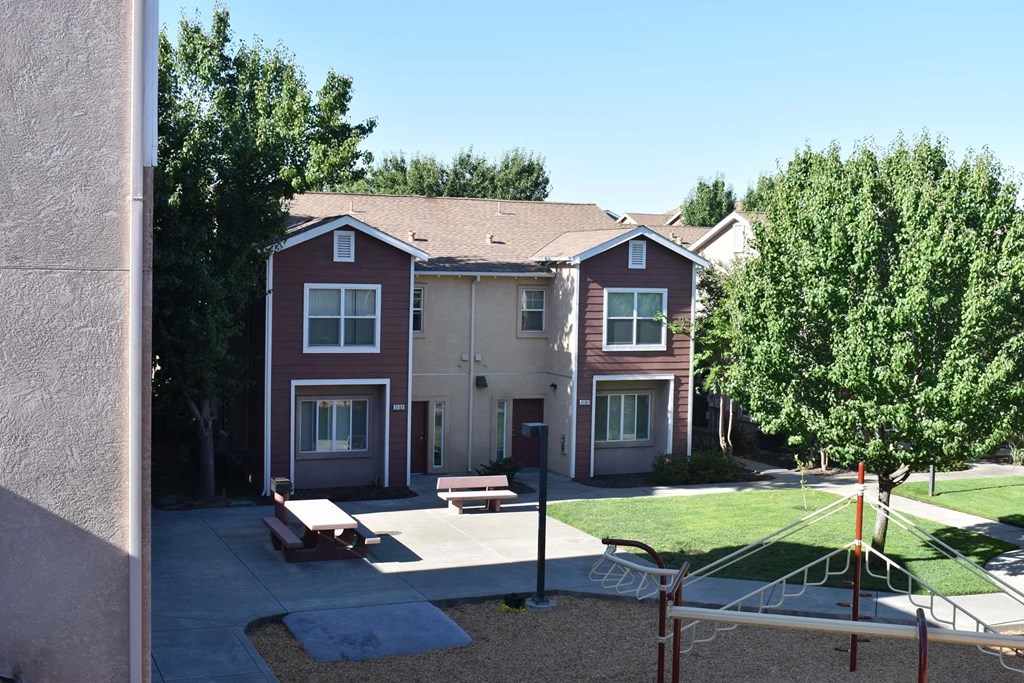 an apartment building with a playground in front of it
