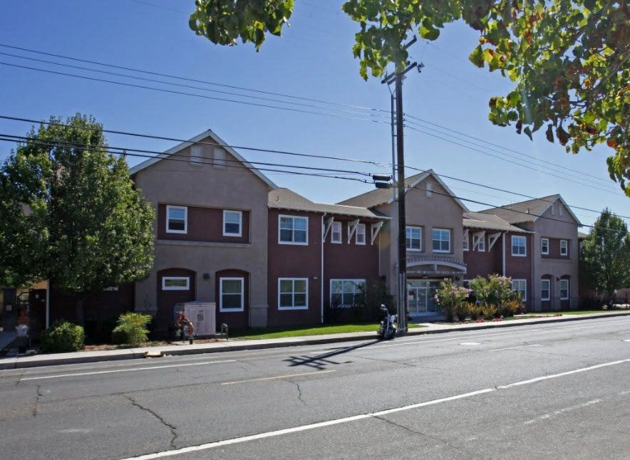 a row of houses on the corner of a street