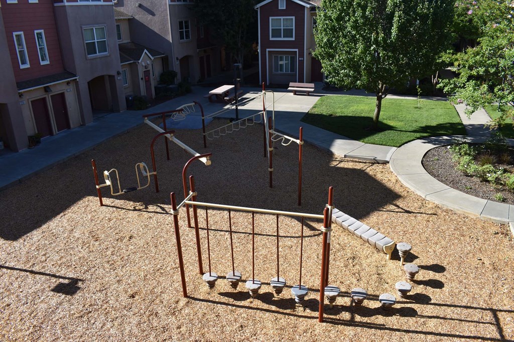 a playground is shown in a yard in front of houses